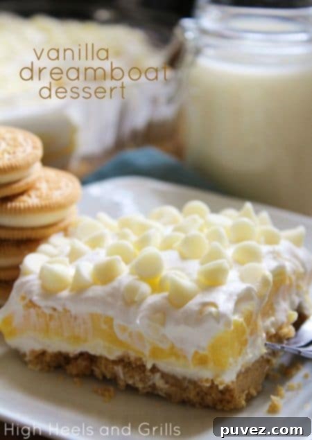 Layers of Vanilla Dreamboat Dessert in a glass serving dish.