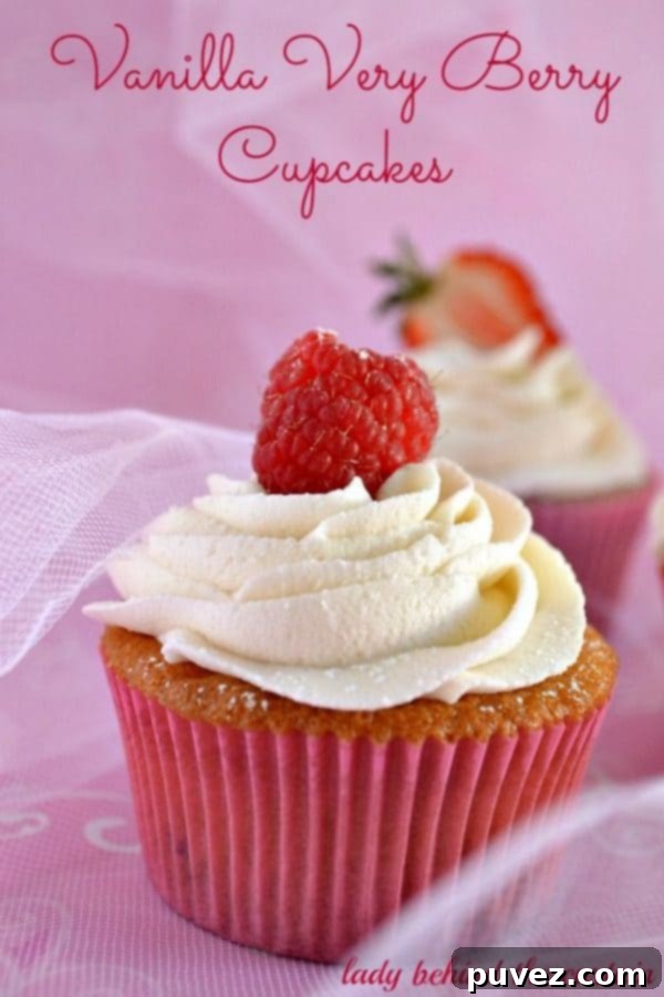 Vanilla Very Berry Cupcakes adorned with fresh berries and frosting.