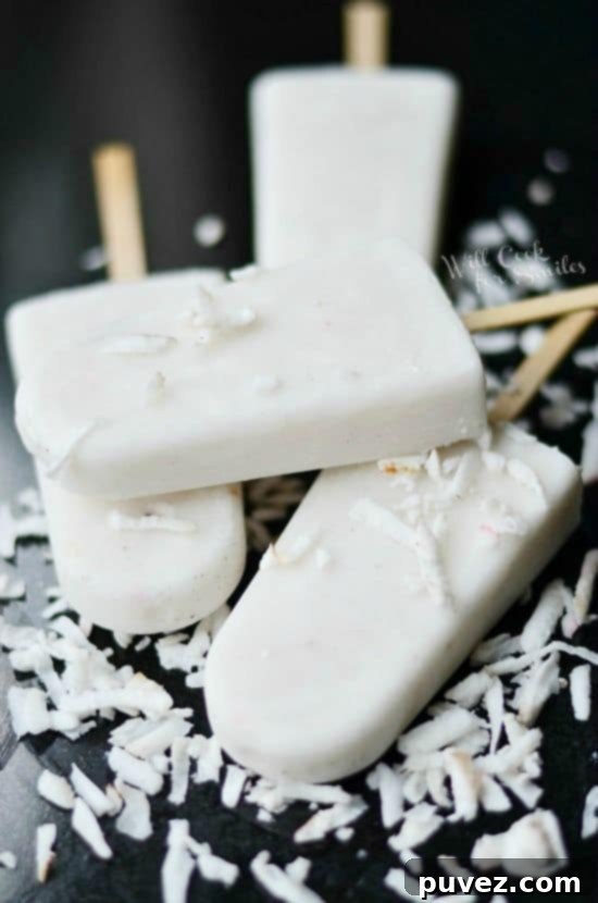 Homemade Coconut Vanilla Creamy Popsicles displayed on a white background.