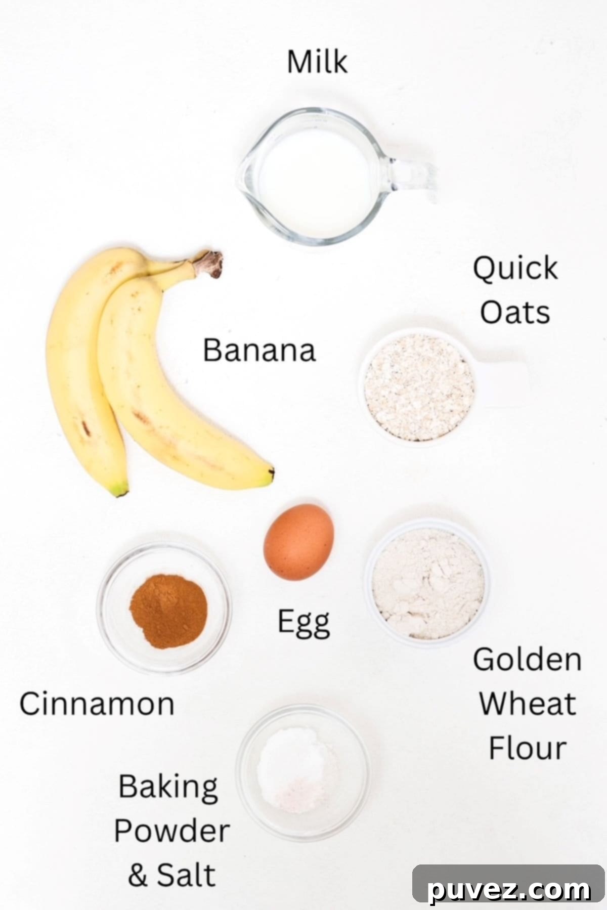 All the essential ingredients for mini banana pancakes laid out and labeled, including overripe bananas, quick oats, and whole wheat flour.