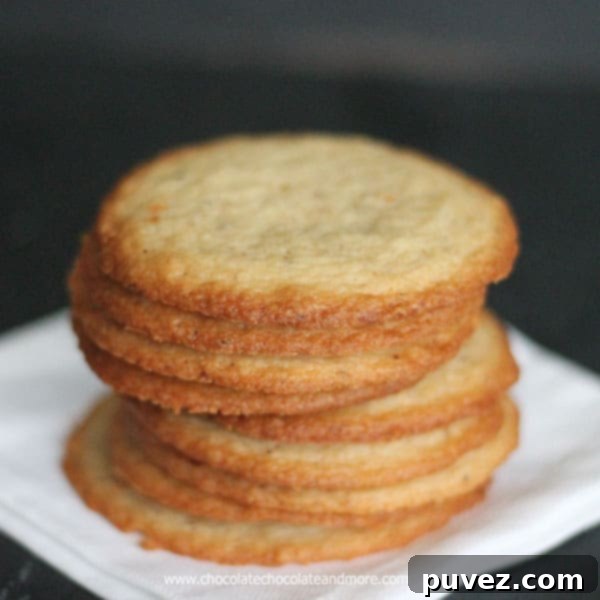 Ingredients for crisp almond cookies laid out on a kitchen counter, featuring chopped almonds