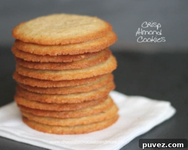Batch of freshly baked crisp almond cookies on a cooling rack, golden brown and inviting