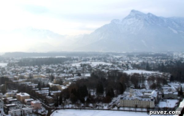 Distant view of the Austrian Alps from Hohensalzburg Fortress, framing the city of Salzburg.