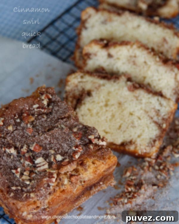 Cinnamon Swirl Quick Bread on a white plate with a fork.