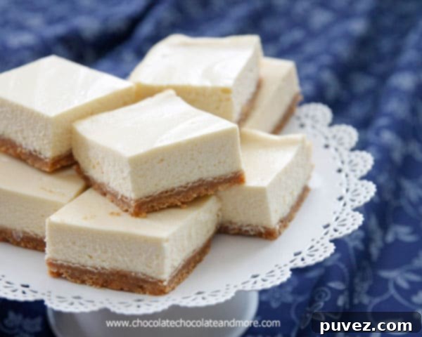 A collection of freshly baked Classic Cheesecake Bars, showcasing their creamy texture and golden crust, ready for serving.