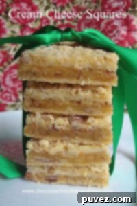 Cream Cheese Squares topped with a delightful crumb, offering a cheesecake-like flavor in bar form.
