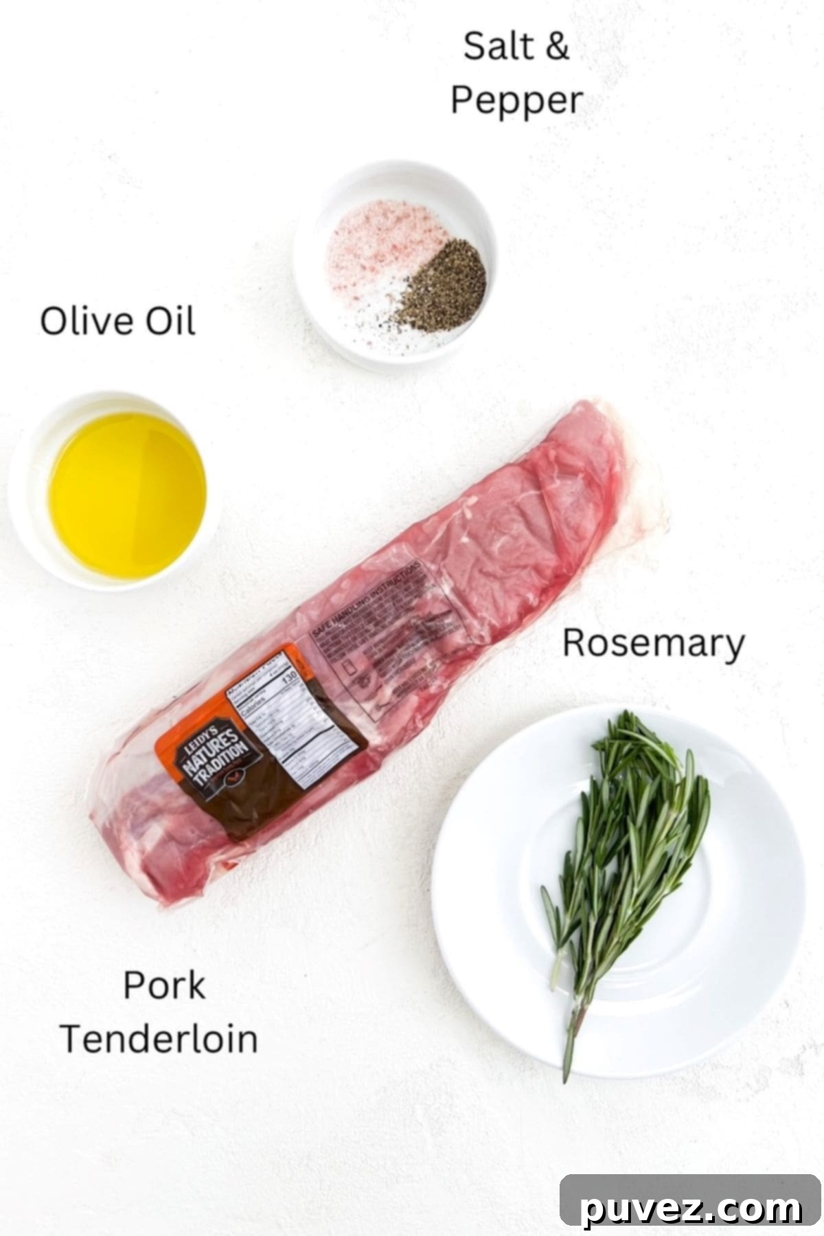 One pork tenderloin in it's package with olive oil, salt and pepper, and fresh rosemary in separate white dishes.