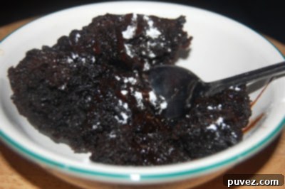 Rich and moist Crock Pot Chocolate Cake, topped with frosting